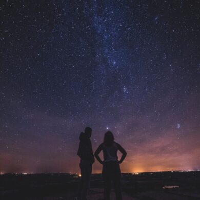 silhouette of people under milky way