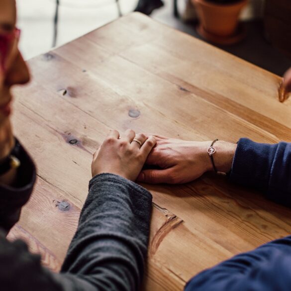 Man and Woman Sitting Together in Front of Table